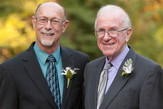 John Cleland with Dr. Einhorn dressed in suites stand together.